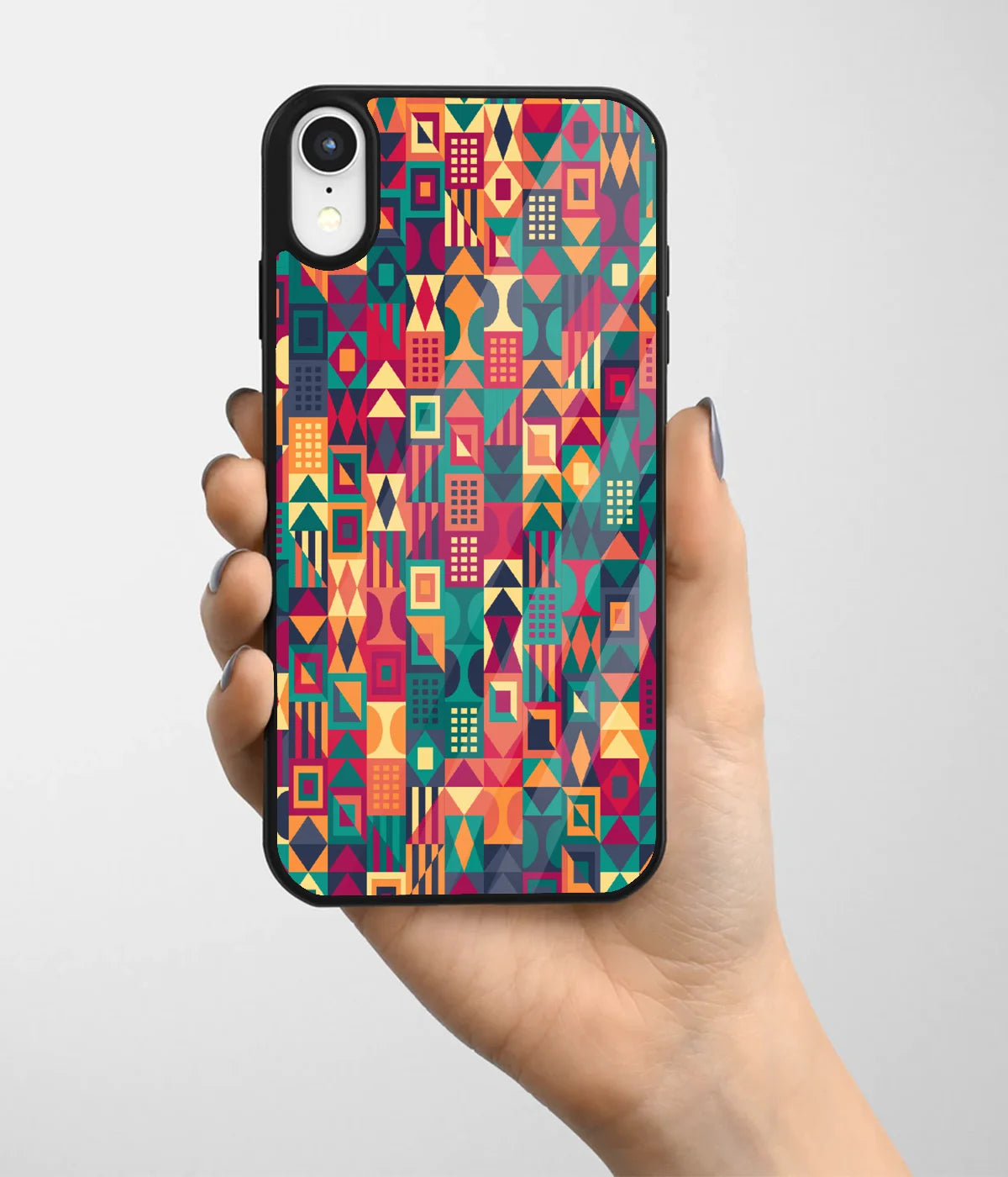 A hand holding a glass phone case with a colorful design.