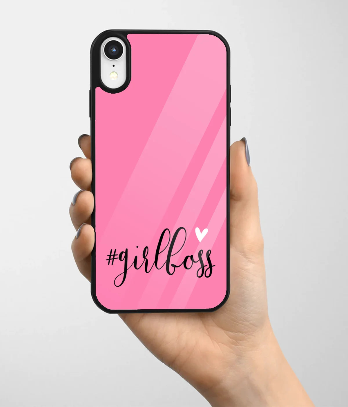 A hand holding a glass phone case with a colorful design.
