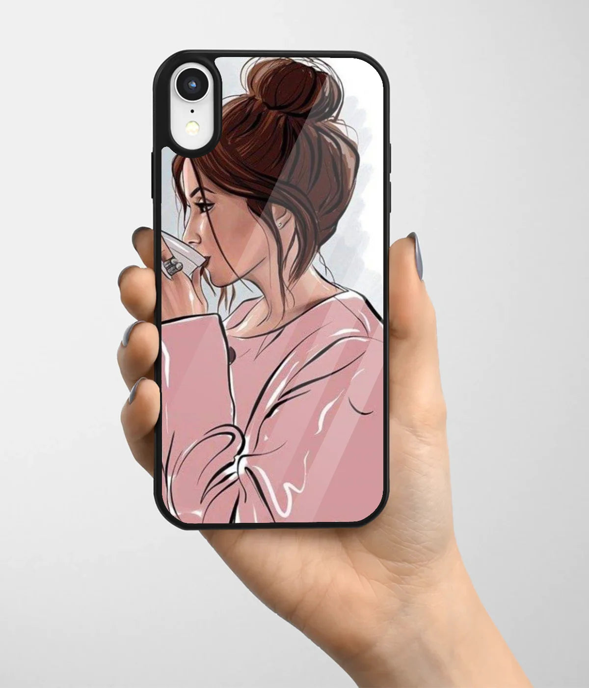 A hand holding a glass phone case with a colorful design.