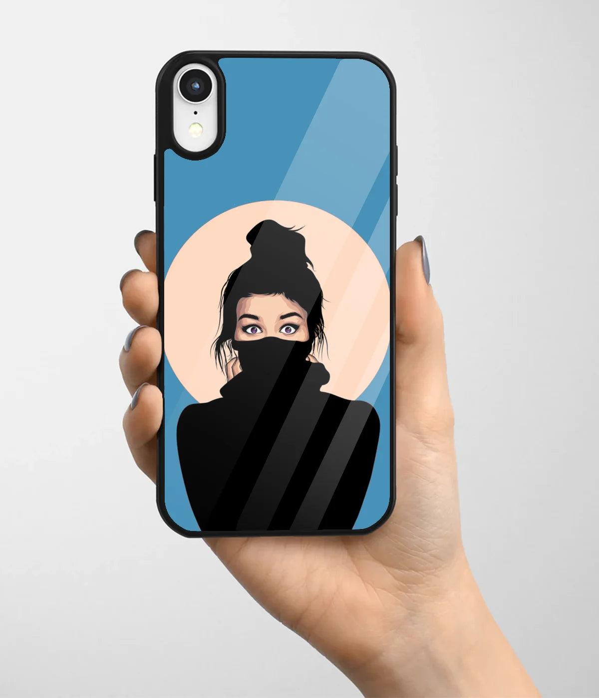 A hand holding a glass phone case with a colorful design.