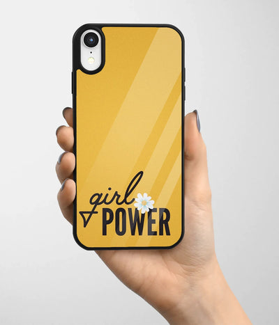 A hand holding a glass phone case with a colorful design.