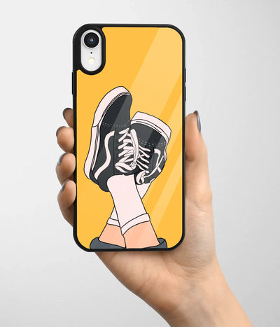 A hand holding a glass phone case with a colorful design.