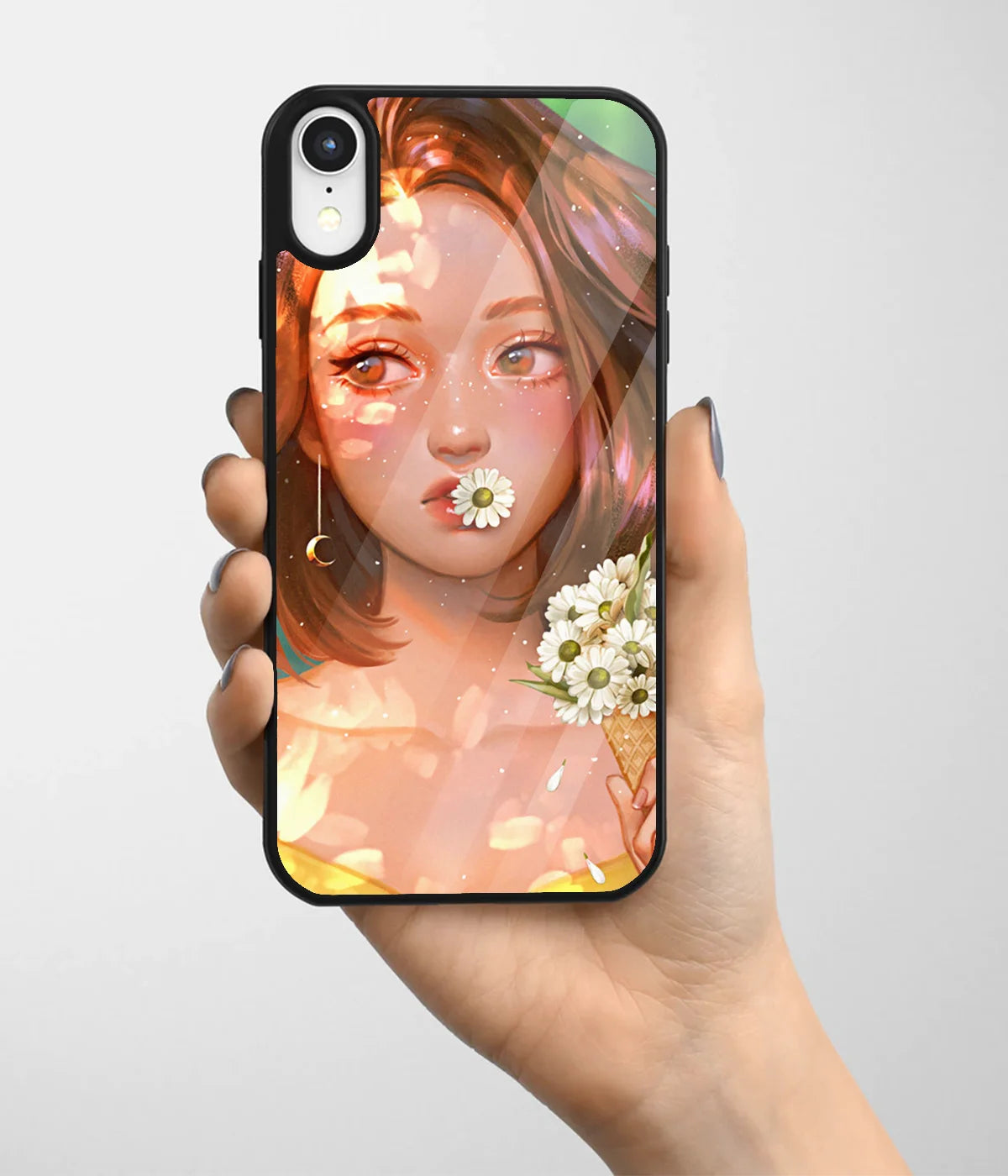 A hand holding a glass phone case with a colorful design.