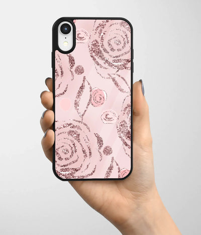 A hand holding a glass phone case with a colorful design.