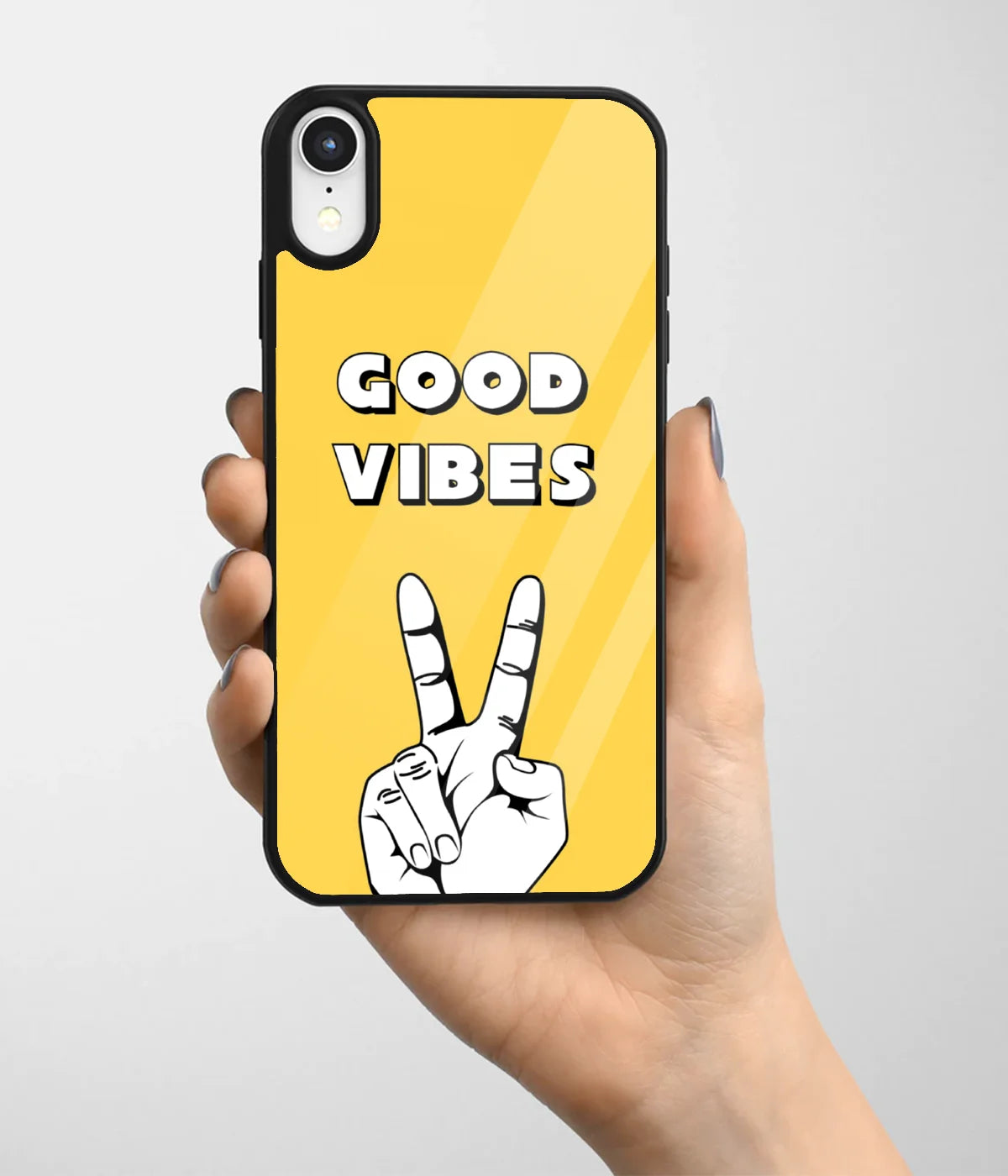 A hand holding a glass phone case with a colorful design.