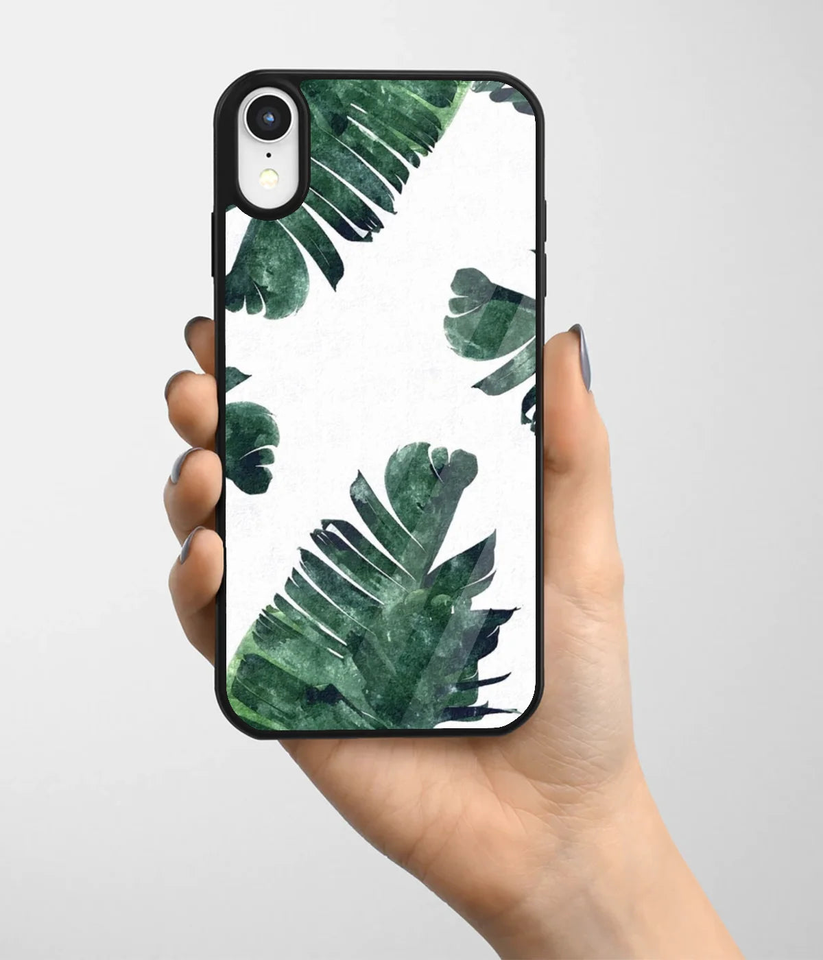 A hand holding a glass phone case with a colorful design.