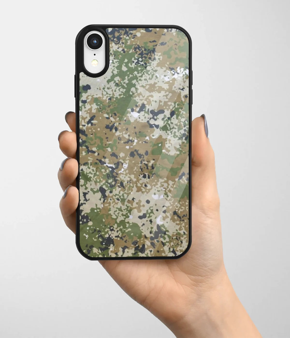 A hand holding a glass phone case with a colorful design.