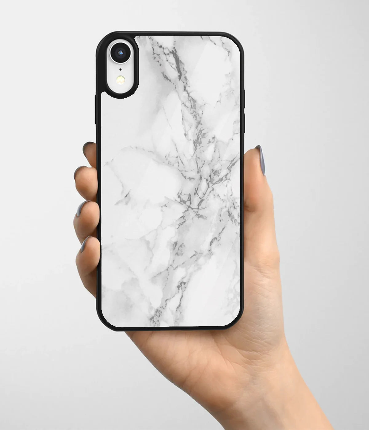 A hand holding a glass phone case with a colorful design.