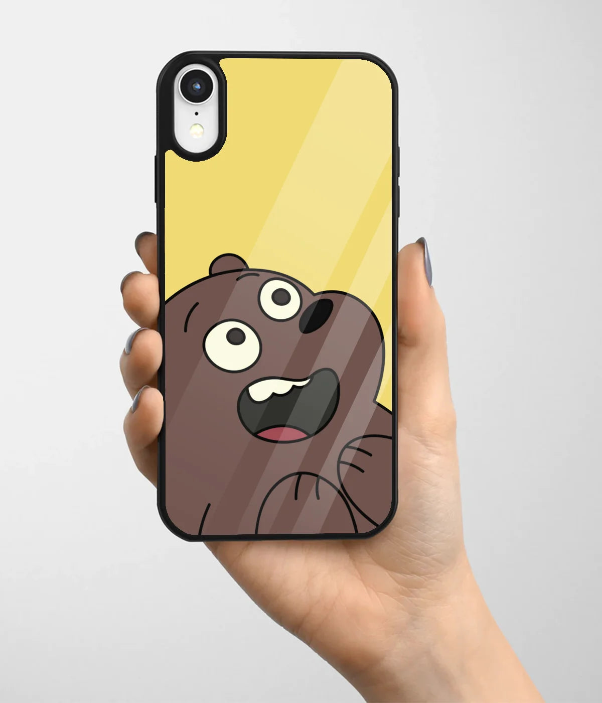 A hand holding a glass phone case with a colorful design.