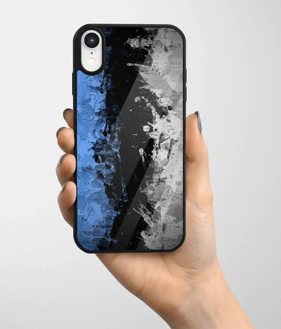 A hand holding a glass phone case with a colorful design.