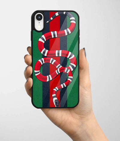 A hand holding a glass phone case with a colorful design.