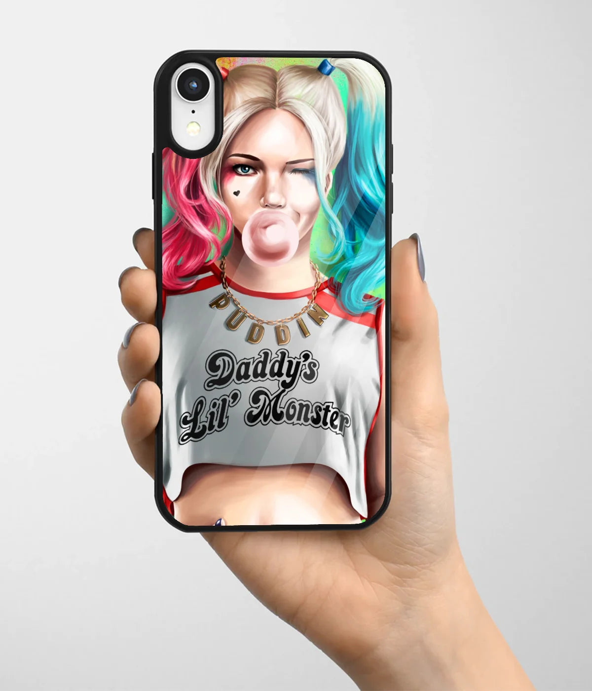 A hand holding a glass phone case with a colorful design.