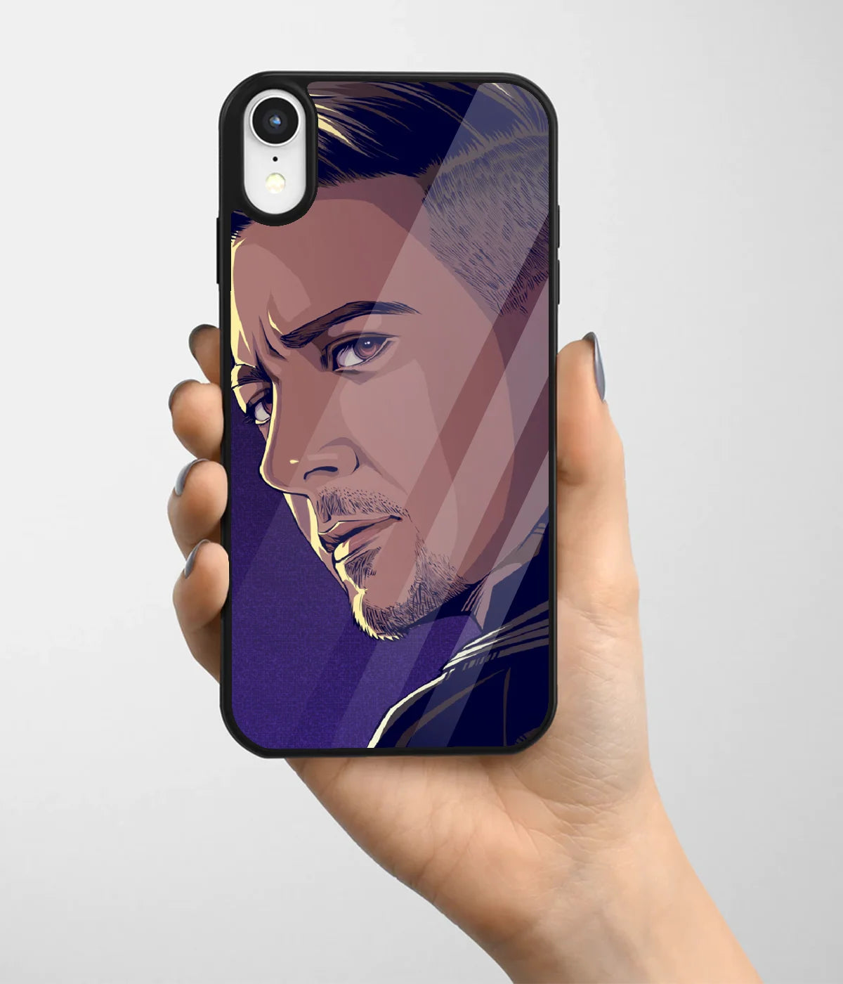 A hand holding a glass phone case with a colorful design.
