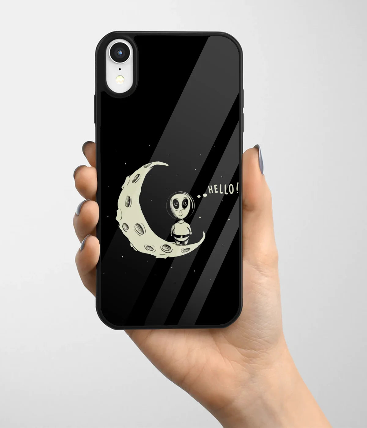 A hand holding a glass phone case with a colorful design.