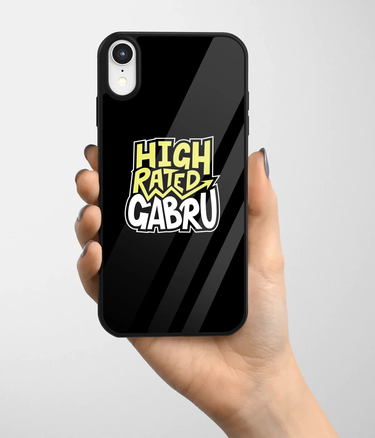 A hand holding a glass phone case with a colorful design.