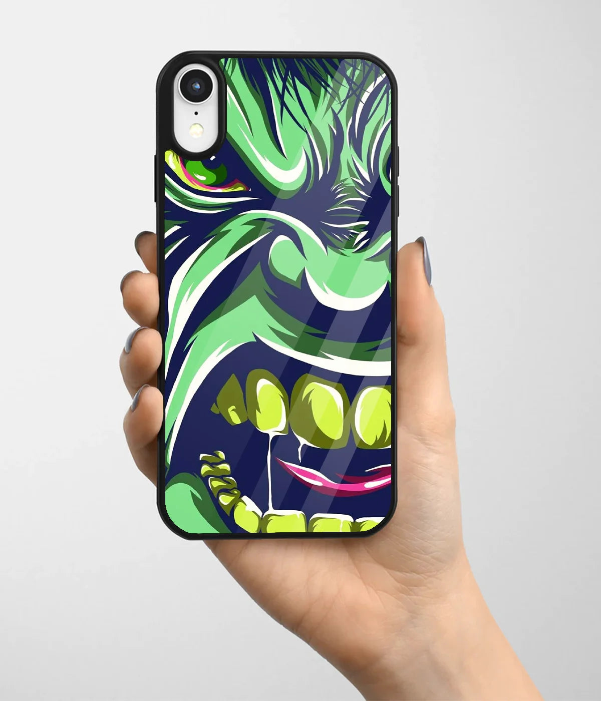 A hand holding a glass phone case with a colorful design.