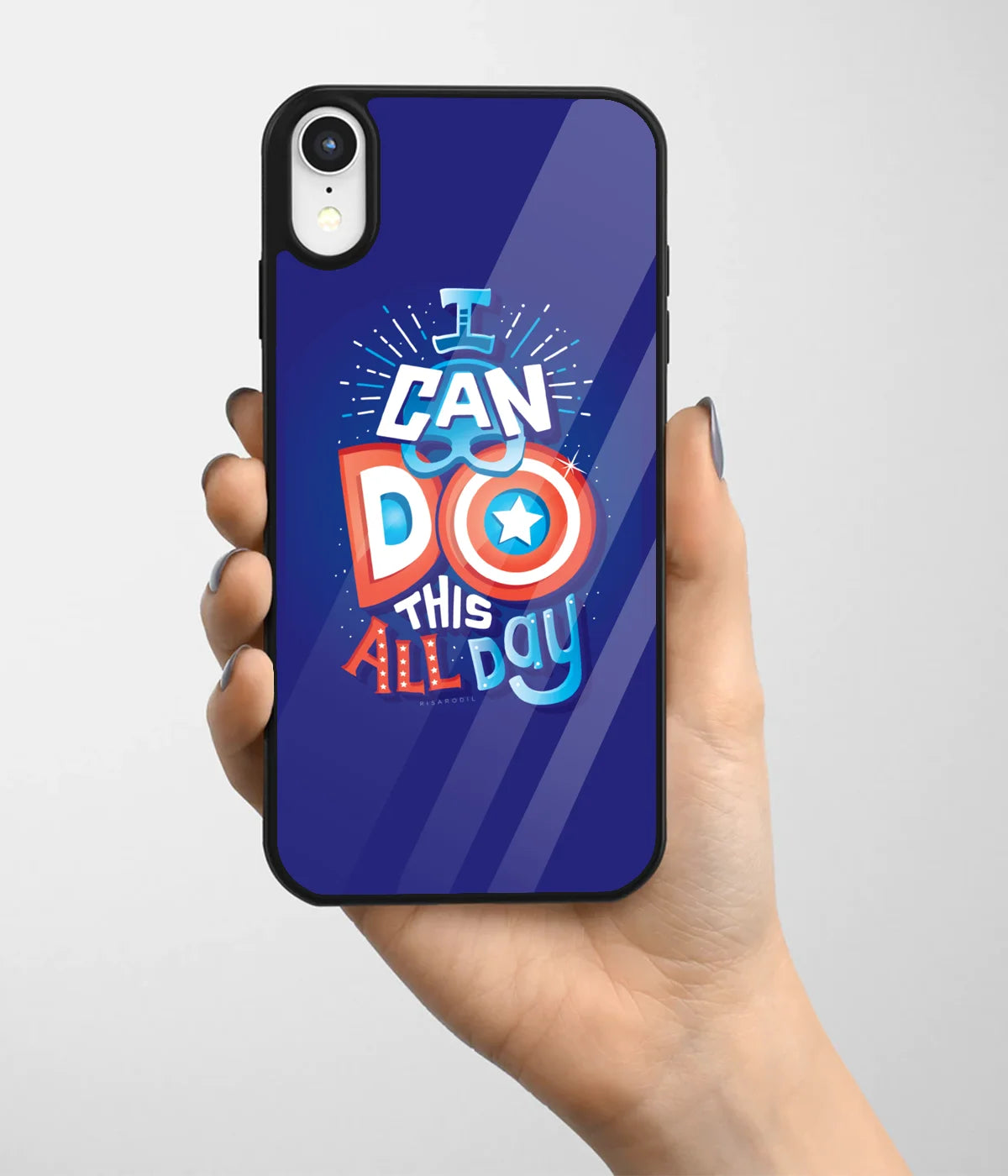 A hand holding a glass phone case with a colorful design.