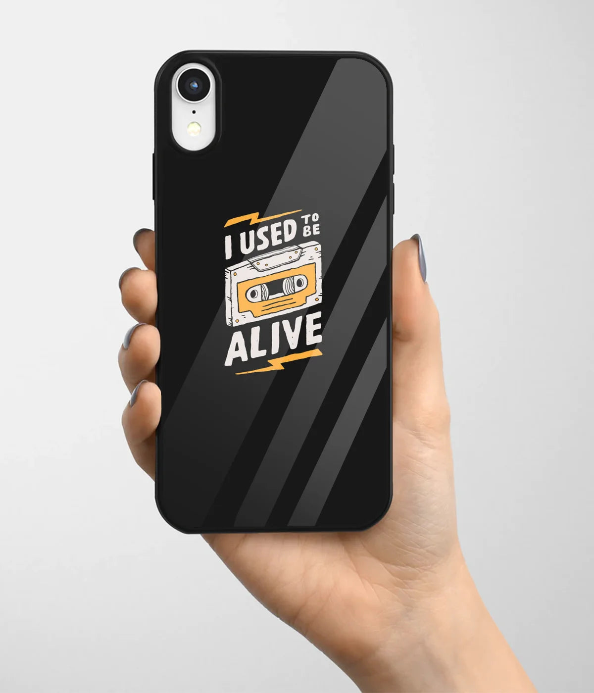 A hand holding a glass phone case with a colorful design.
