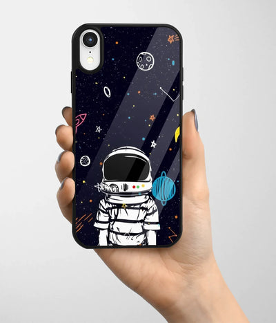 A hand holding a glass phone case with a colorful design.