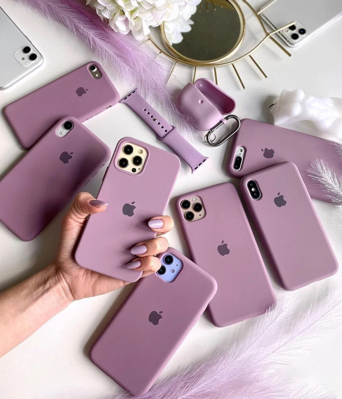 Multiple black currant iPhone silicone cases on a white surface.