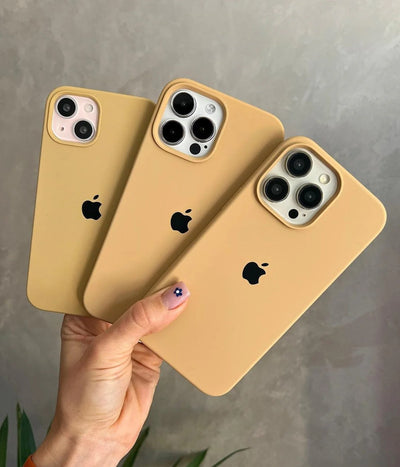 Multiple mustard yellow iPhone silicone cases on a white surface.