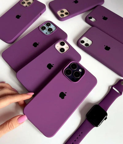 Multiple purple iPhone silicone cases on a white surface.
