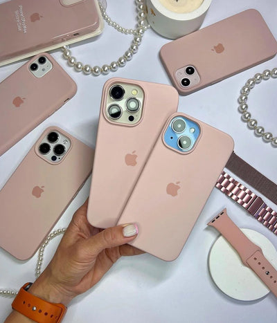 Multiple sand pink iPhone silicone cases on a white fabric background