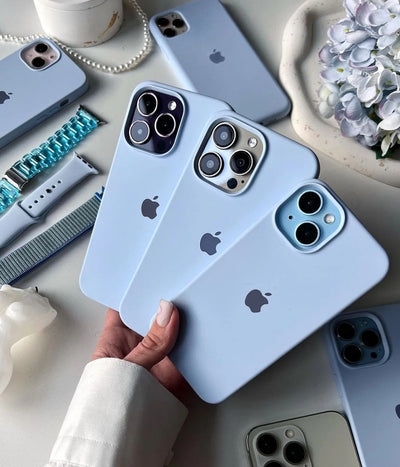 Multiple sky blue iPhone silicone cases on a white surface.