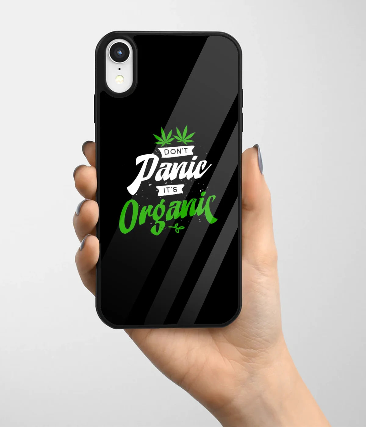 A hand holding a glass phone case with a colorful design.