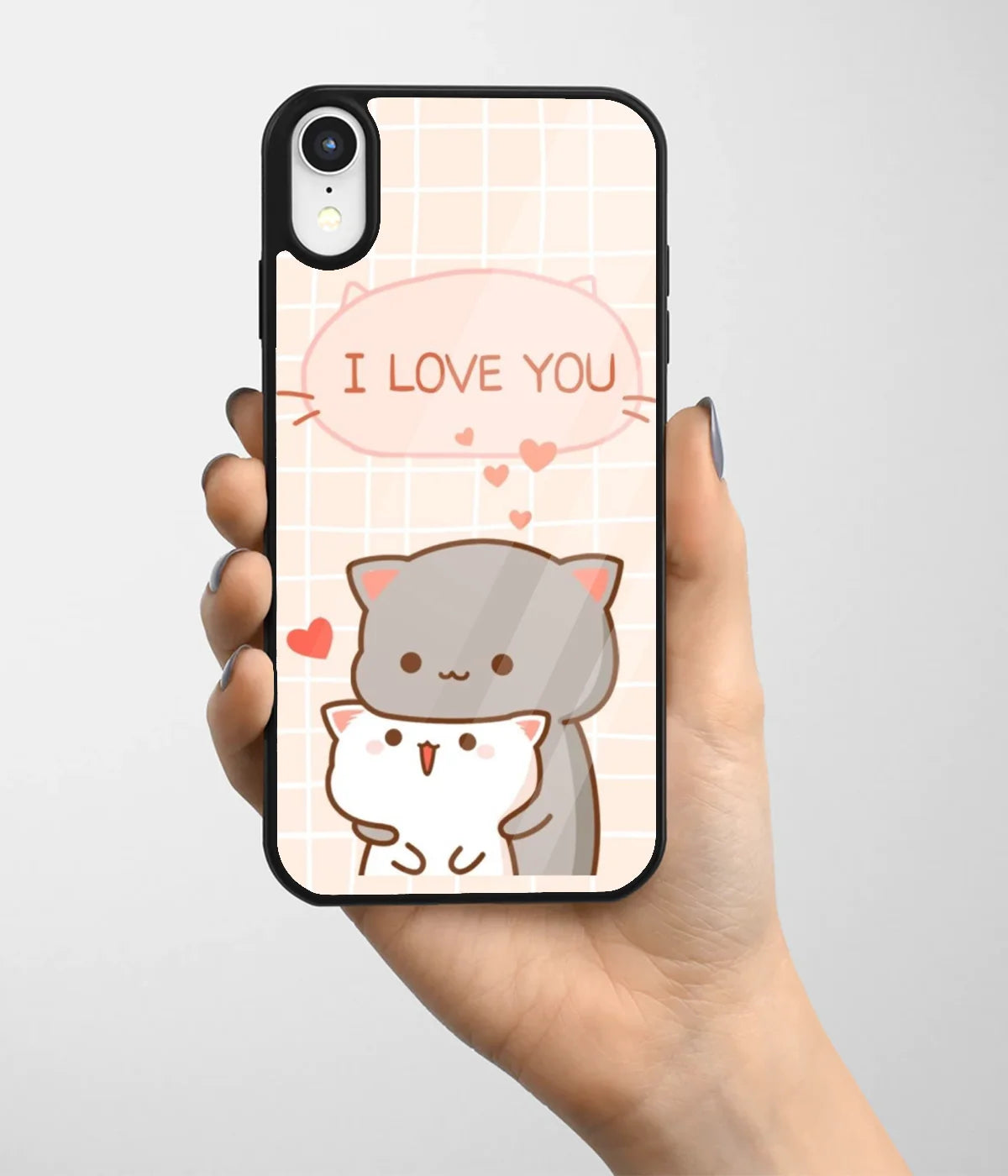 A hand holding a glass phone case with a colorful design.