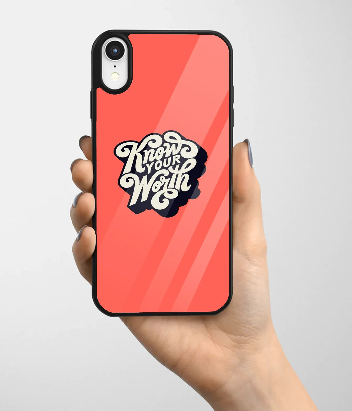 A hand holding a glass phone case with a colorful design.