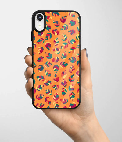 A hand holding a glass phone case with a colorful design.
