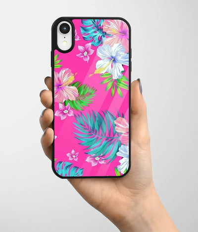 A hand holding a glass phone case with a colorful design.