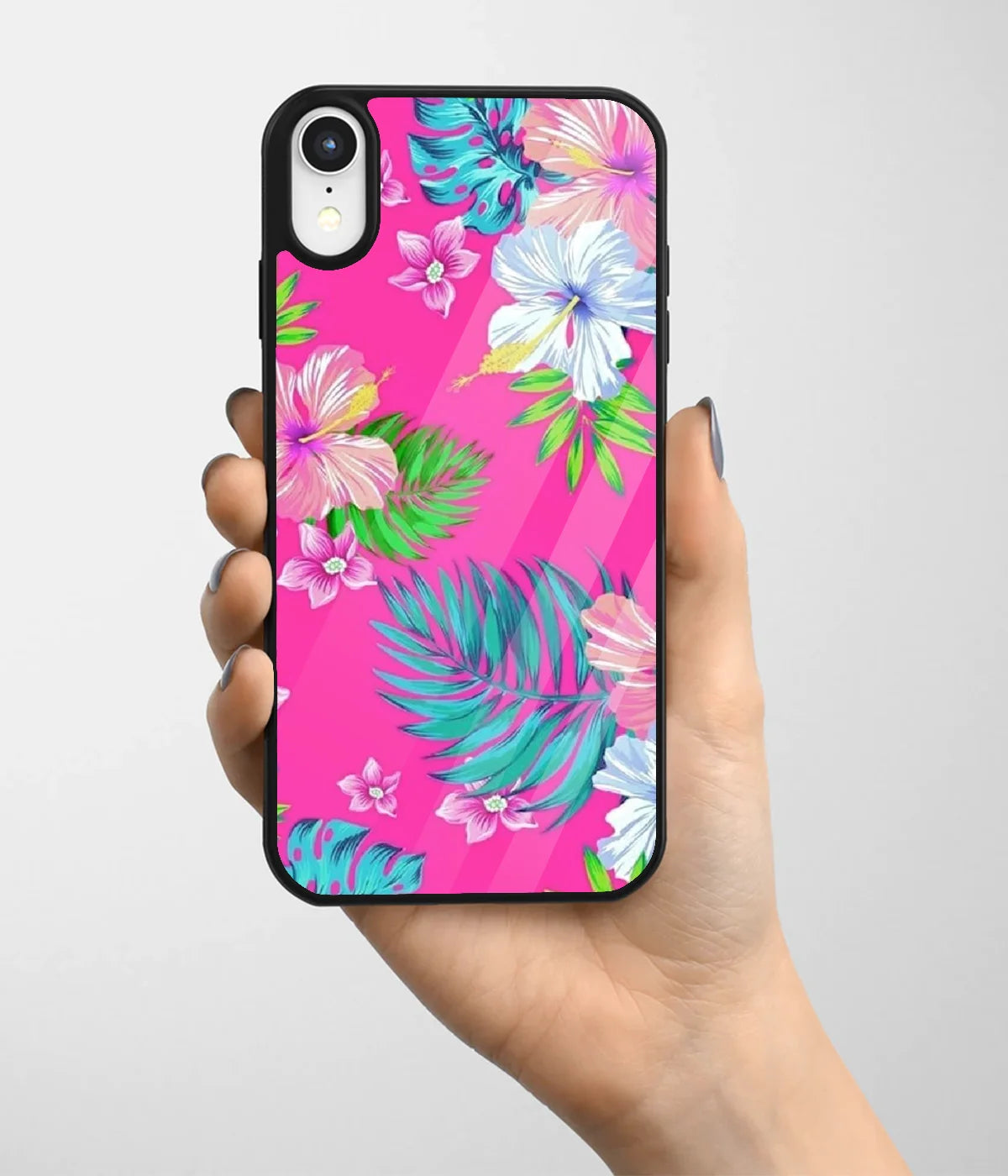 A hand holding a glass phone case with a colorful design.