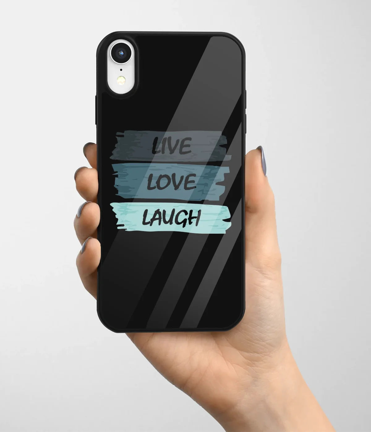 A hand holding a glass phone case with a colorful design.