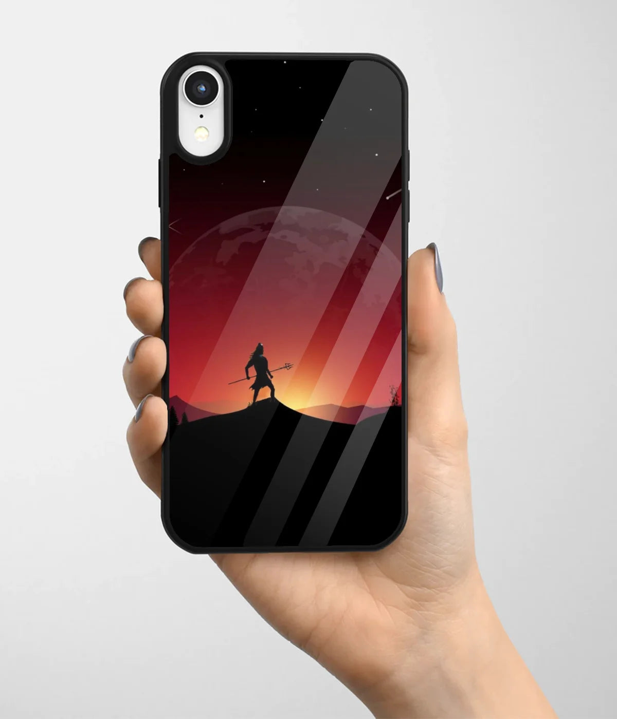 A hand holding a glass phone case with a colorful design.
