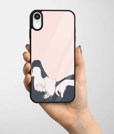 A hand holding a glass phone case with a colorful design.