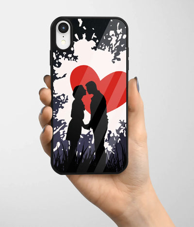 A hand holding a glass phone case with a colorful design.