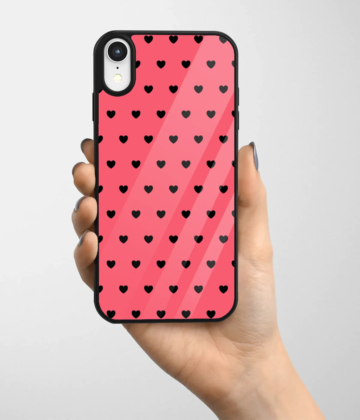 A hand holding a glass phone case with a colorful design.