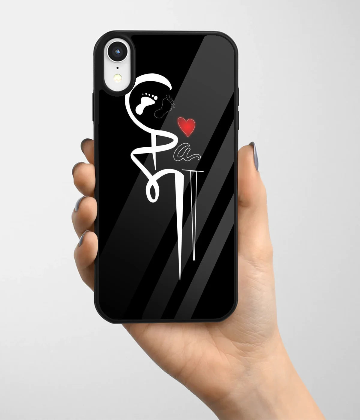 A hand holding a glass phone case with a colorful design.