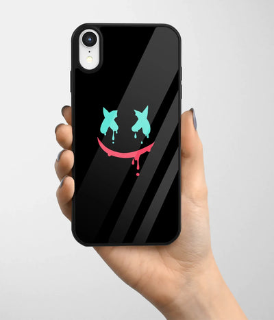 A hand holding a glass phone case with a colorful design.