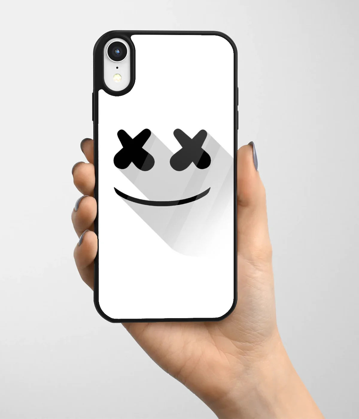 A hand holding a glass phone case with a colorful design.