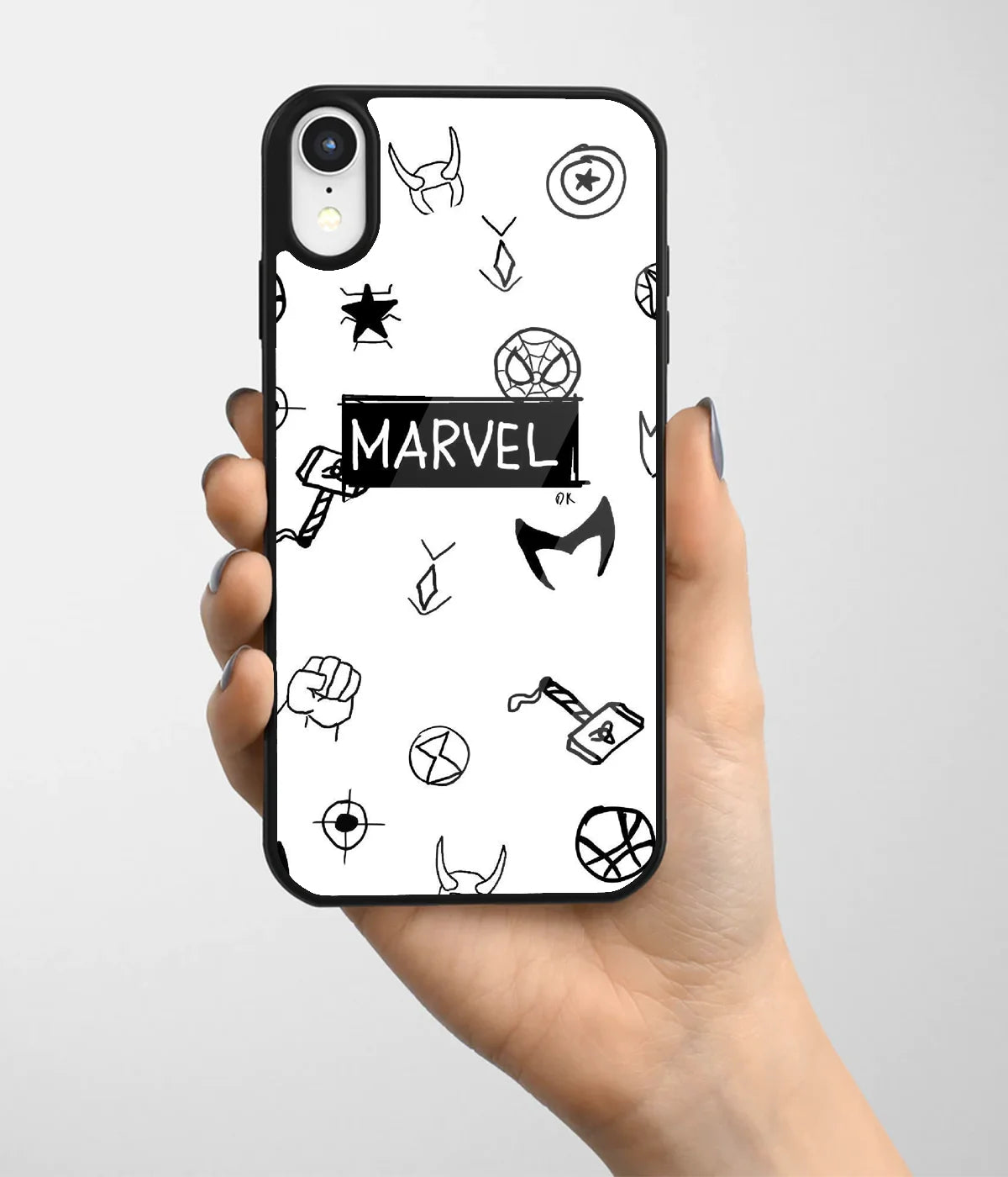 A hand holding a glass phone case with a colorful design.