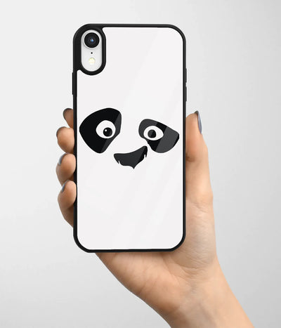 A hand holding a glass phone case with a colorful design.