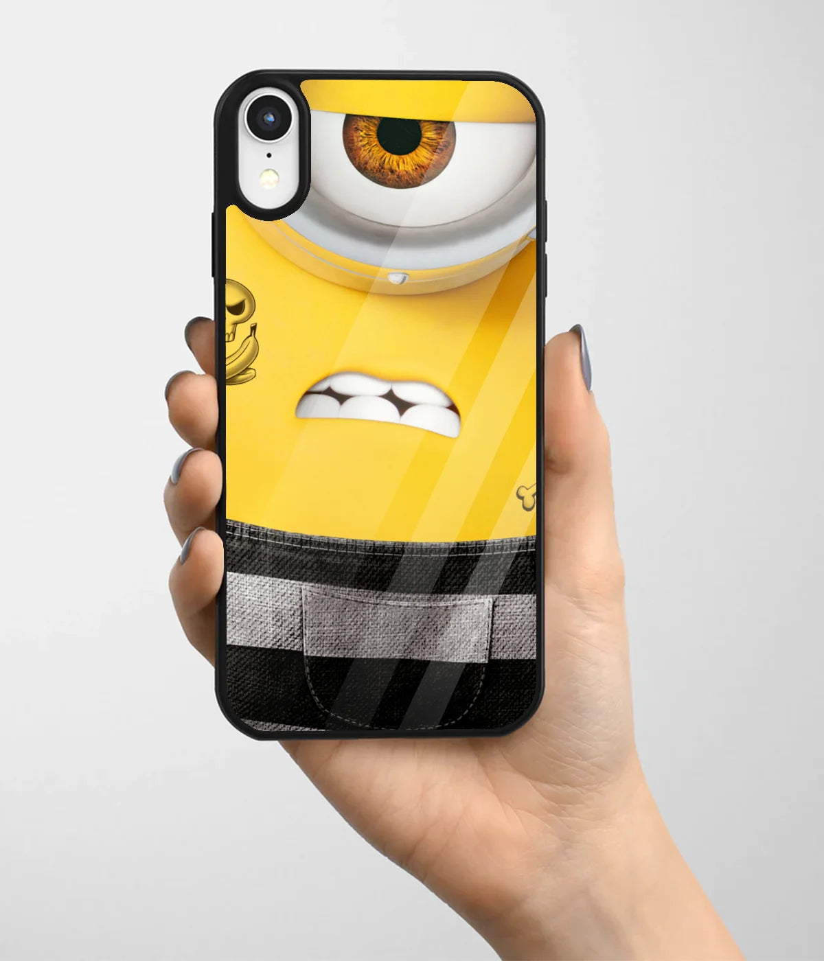 A hand holding a glass phone case with a colorful design.