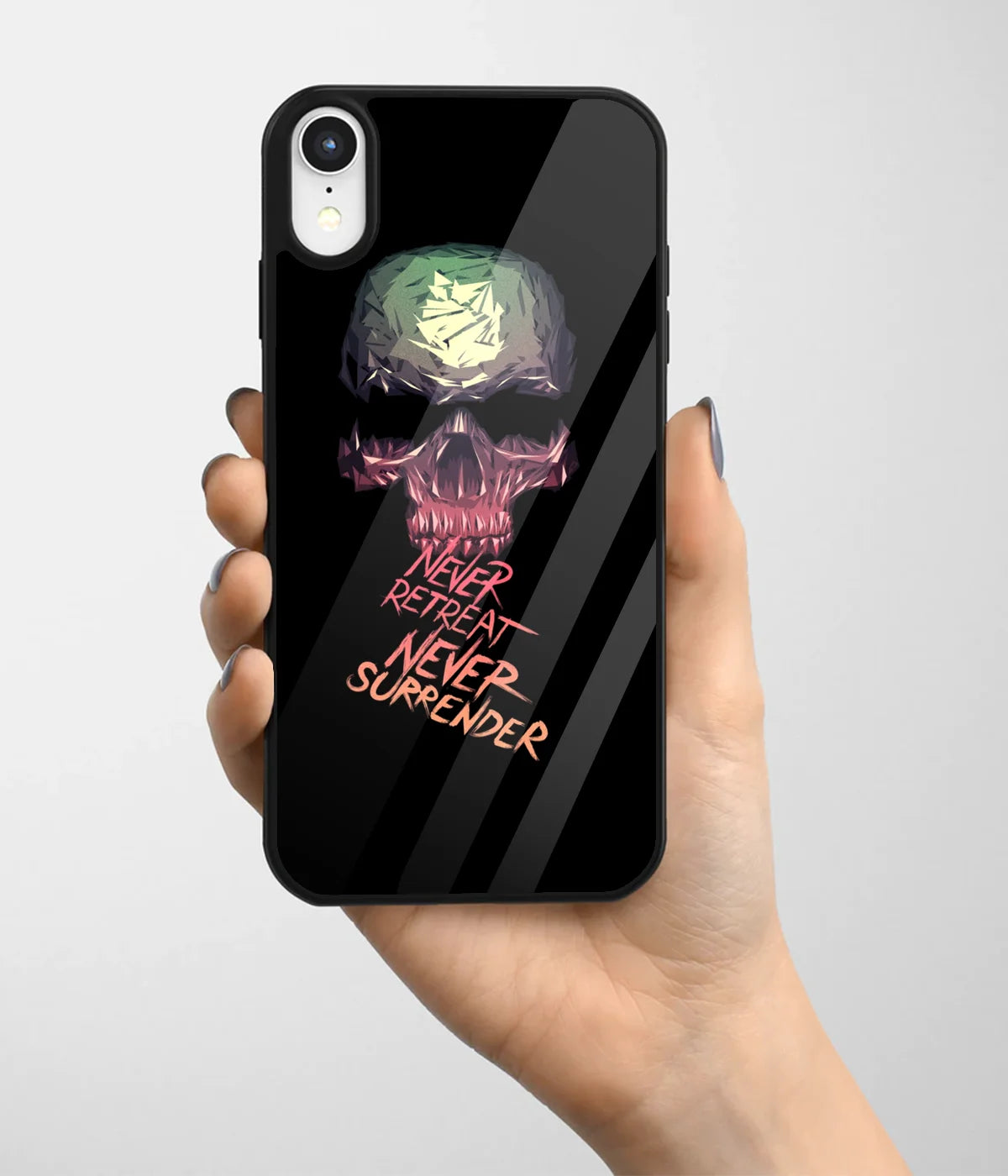 A hand holding a glass phone case with a colorful design.