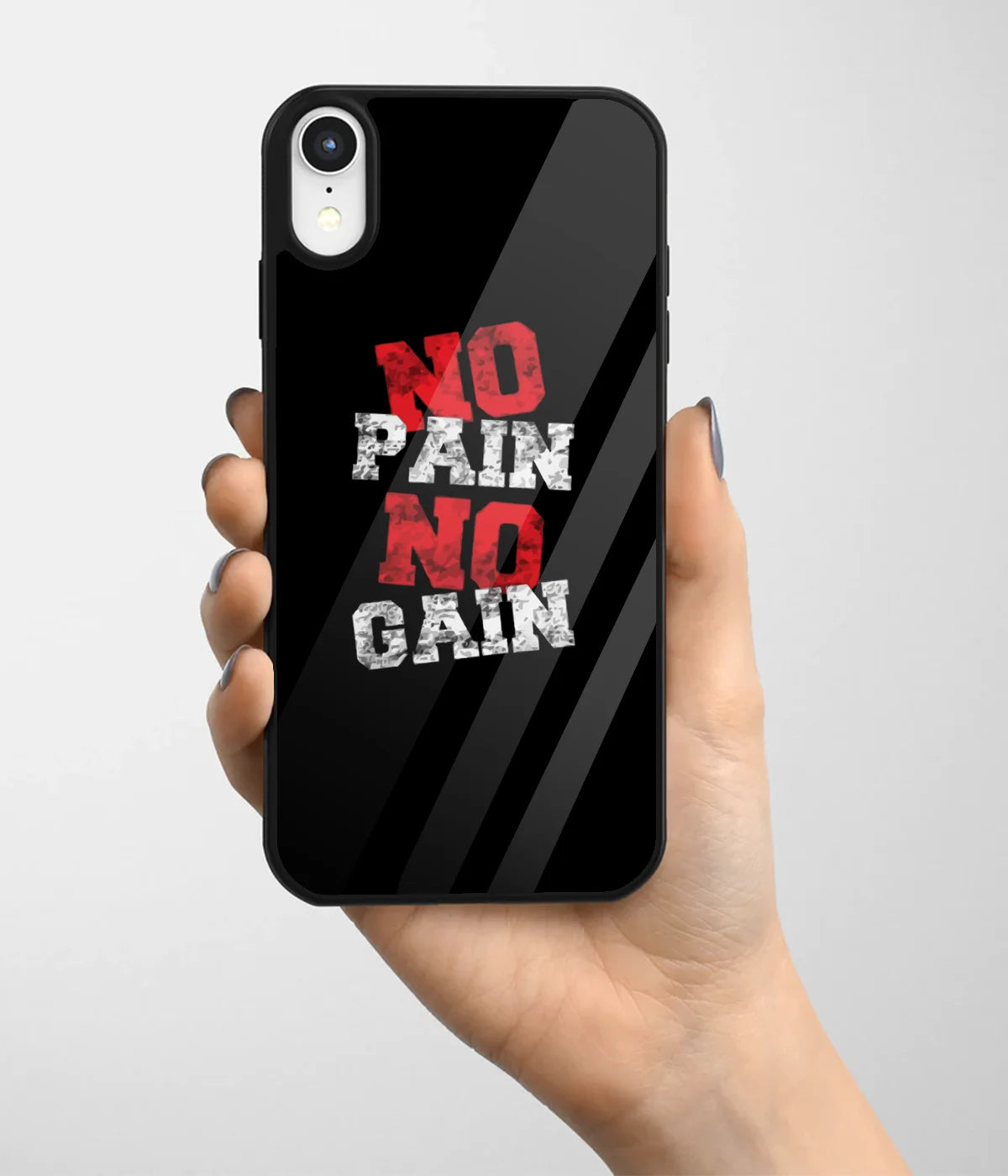 A hand holding a glass phone case with a colorful design.