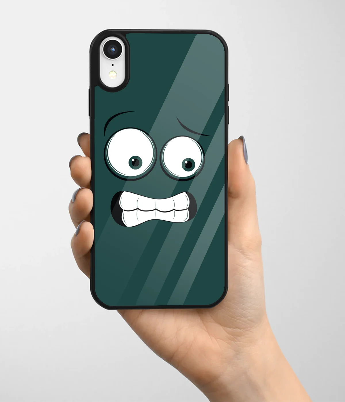 A hand holding a glass phone case with a colorful design.