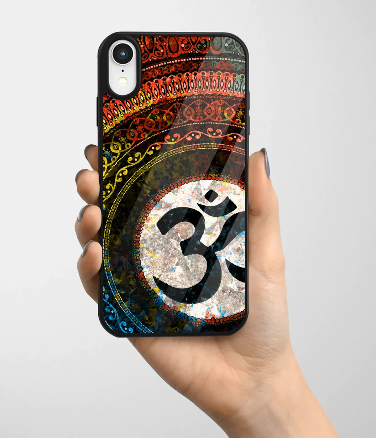 A hand holding a glass phone case with a colorful design.