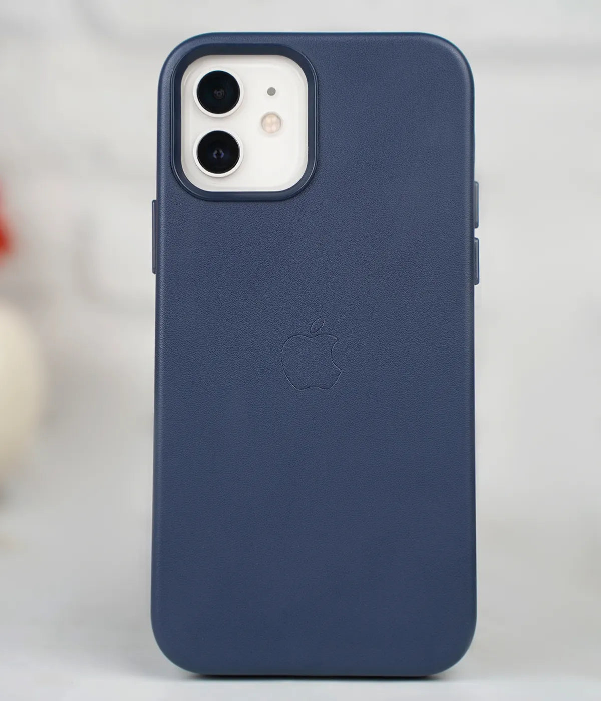 Full back view of an iPhone protected by the premium Deep Navy leather case, featuring a sleek design and an embossed Apple logo.